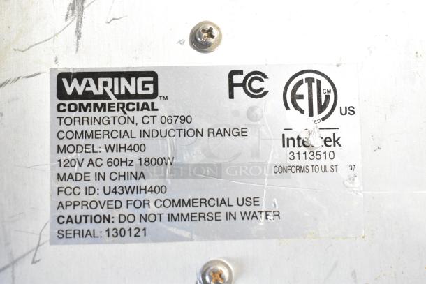 Waring WIH400 stainless steel induction range label showing model, voltage, FCC ID, and commercial use instructions.