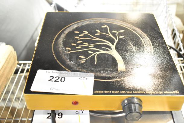 Metal countertop single burner induction range with decorative tree design, dial control, and auction tag number 220.