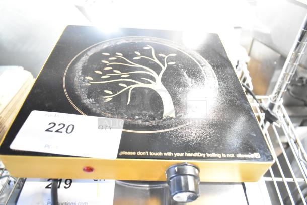 Metal countertop single burner induction range with decorative tree design, knob control, fair condition. Auction tag reads "220 QTY."