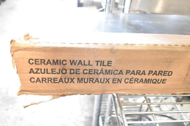 Box of ceramic wall tile, labeled in English, Spanish, and French. Box shows slight wear. Ideal for decorating projects.