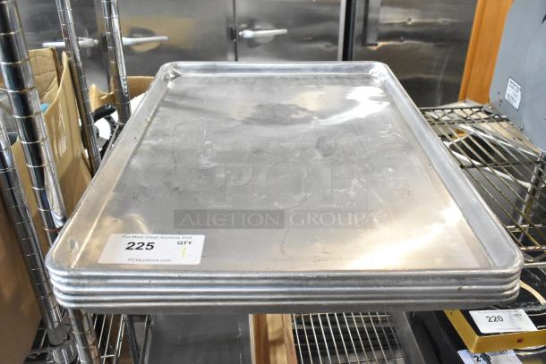 Five full-size metal baking pans stacked. Good condition. Auction tag reads "225 QTY 1," indicating sale details.