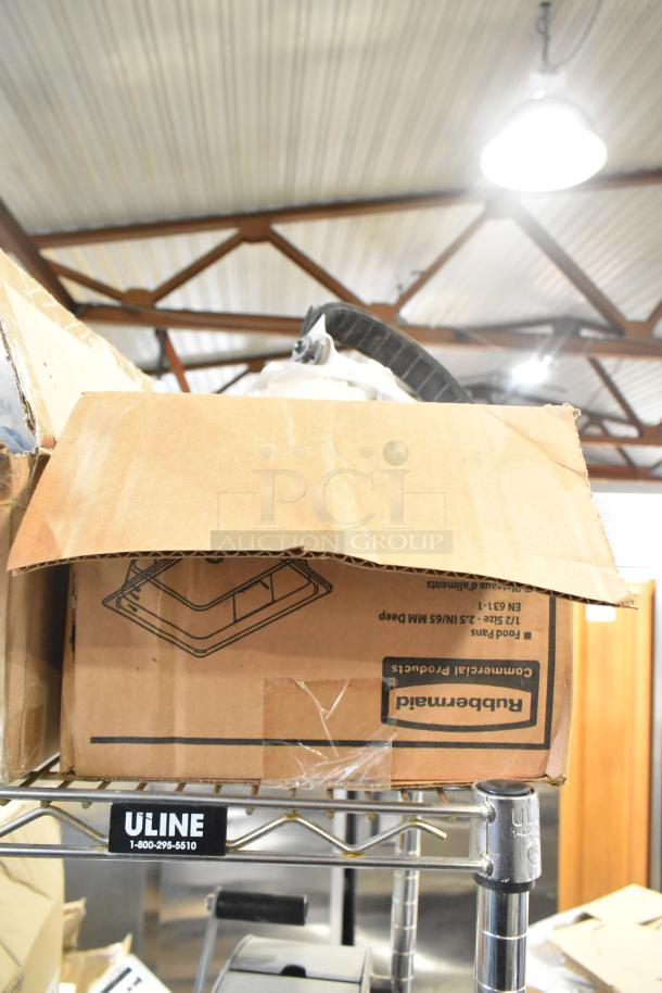 Cardboard box labeled "Rubbermaid" on metal shelf, containing various items like amber drop-in bins, cables, and brackets.