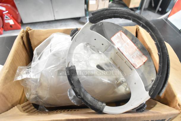 Box with assorted items including a plastic-wrapped Rubbermaid bin, metal brackets, and cables. Visible label with instructions.