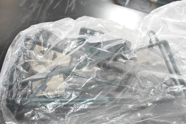 Auction lot of mixed items, including Rubbermaid amber bins, cables, and brackets, in clear plastic wrapping.