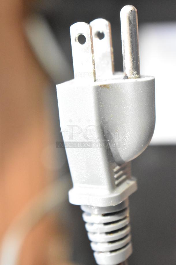 Close-up image of a plug from a Black & Decker countertop microwave oven, 120 volts, 1 phase.