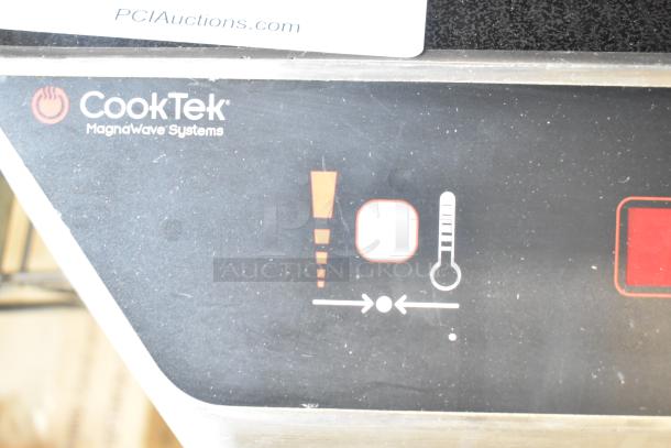 CookTek MC1800 induction range control panel, black surface with symbols and CookTek branding. Model details partially visible.