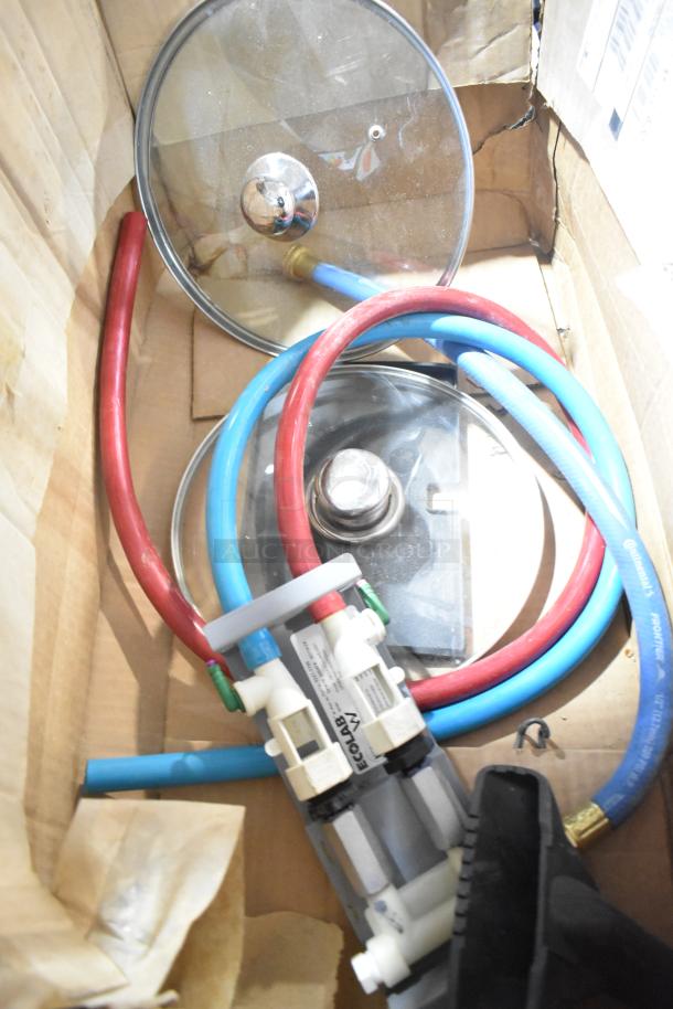 Lot of various items in a box, including glass lids, red and blue hoses, and an Ecolab connector assembly.