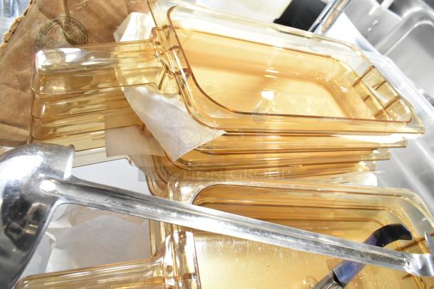 Stack of amber poly bins with a glass lid and silver ladle. Items appear lightly used, suitable for kitchen storage or serving.