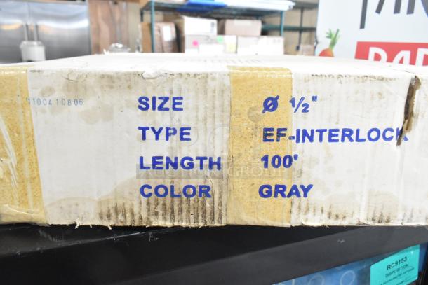 Global Manufacturing EF-INTERLOCK hose, 100' length, 1/2" diameter, gray color. Box shows wear with visible markings.