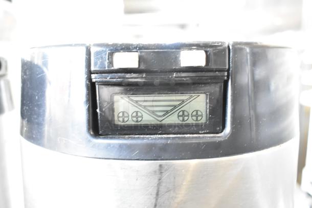 2 metal countertop beverage holder dispensers, stainless steel with digital display. Used condition, minor surface scratches.