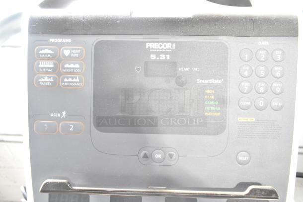 Precor floor style elliptical control panel, features heart rate monitor, multiple exercise programs, and user settings.