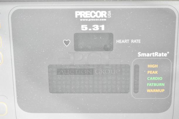 Precor elliptical display showing heart rate and SmartRate indicators, under normal use conditions.