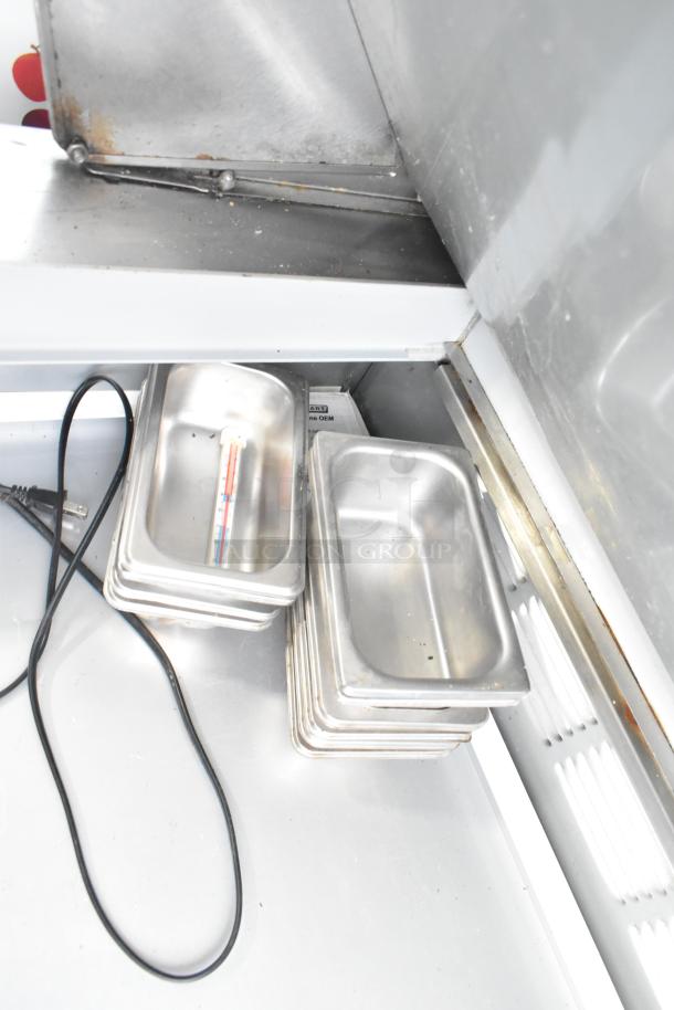 Beverage Air SPE48-18M stainless steel prep table in used condition, includes pans and thermometer, on casters, 115 volts.