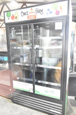 2024 True TVM-48SL-HC 2-door reach-in cooler, metal shelves, 115V, like new condition, branded graphics on display.