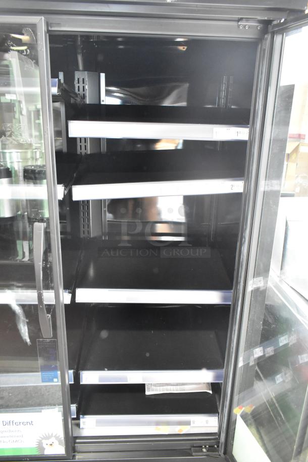2024 True TVM-48SL-HC 2 Door Reach-In Cooler, metal shelves, black interior, commercial use, 115 volts, excellent condition.