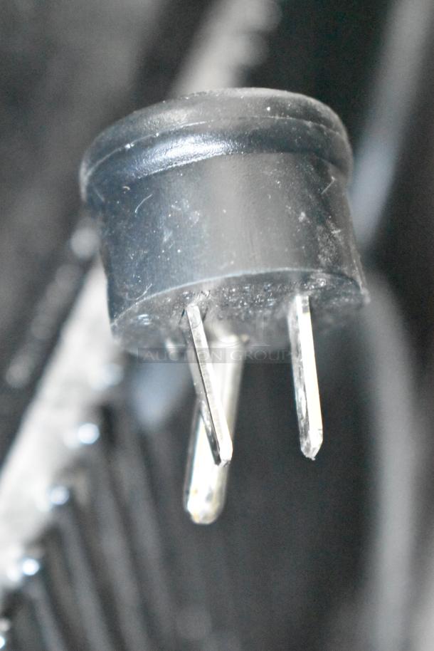 Close-up of a power plug for the 2024 True TVM-48SL-HC 2 Door Reach In Cooler, 115 Volts, 1 Phase.