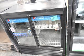 True GDM41SL48-HC-LD commercial 2-door reach-in cooler, visible Pepsi branding, poly coated racks, good condition.