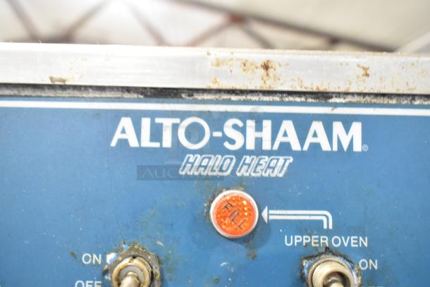 Alto Shaam 1000-TH Halo Heat oven control panel with upper oven indicator and switches, showing wear and use.