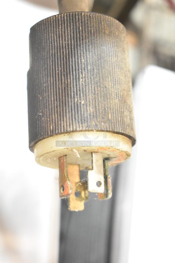 Close-up of power plug for Groen HY-3E electric steam cabinet, showing worn condition with dust and slight corrosion.