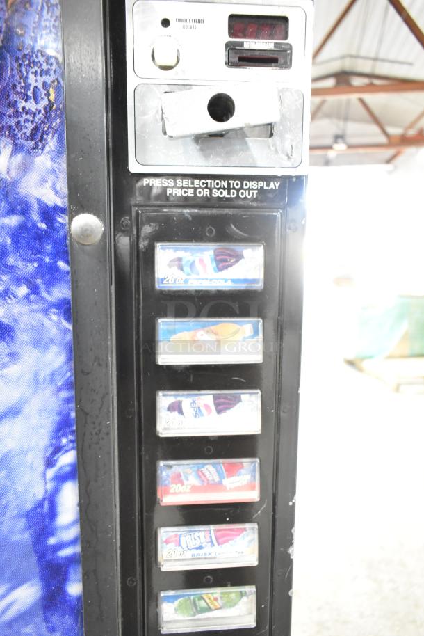 Metal commercial bottle vending machine, 115 volts, 1 phase, displaying soda selections and coin mechanism; used condition.