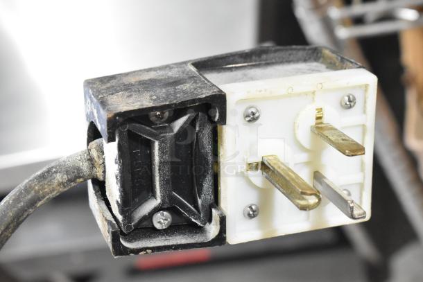 Close-up of a plug for Star Pro Max Stainless Steel Commercial Countertop Double Panini Press, showing wear.