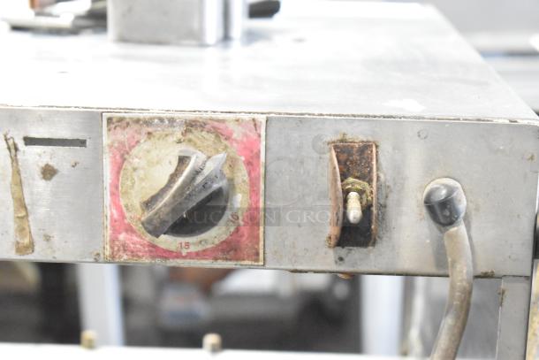 Metal commercial countertop warmer, 115 volts, 1 phase, with visible temperature control dial and switch, shows signs of wear.