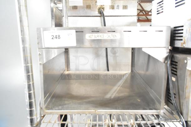 Metal countertop warmer, 115 volts, 1 phase, stainless steel, visible caution label, tag indicating item #248.