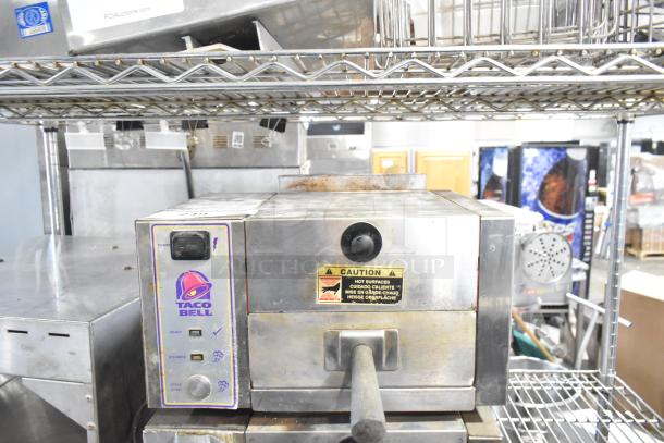 Roundup stainless steel commercial Taco Bell food steamer, 208 volts, 1 phase, caution label visible. Used condition.