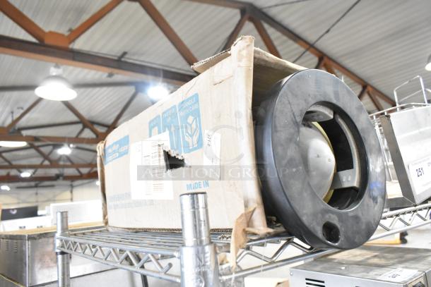 Tiered lot of various items, including a cup dispenser in a worn box, fry basket, and metal pieces on a shelf.