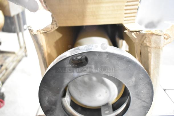 Tier lot of various items, including a metal cup dispenser and fry basket, in a worn cardboard box. Items appear used.