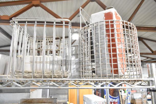 Tiered lot of various items, including a metal cup dispenser, fry basket, and stainless steel pieces on a shelf. Features industrial wire design.