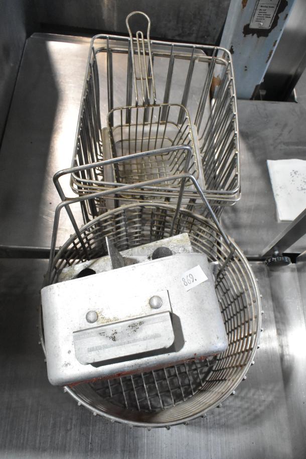 Tiered lot with a cup dispenser, fry basket, and metal pieces. Visible wear, label reads "869."