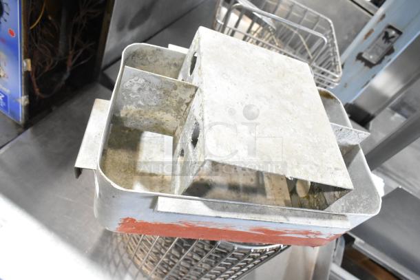 Tier lot includes a cup dispenser, fry basket, and metal pieces. Items show wear and signs of use. Suitable for parts.