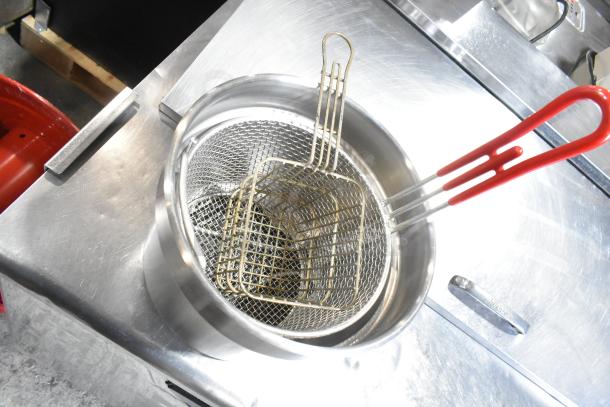 Various kitchen items lot including a metal fry basket with red handles, visible inside a stainless-steel container.