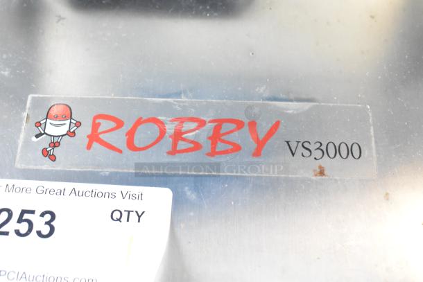 Robby VS3000 Metal Commercial Dry Steam Cleaner label with robot graphic. 115 Volts, 1 Phase. Visible wear.