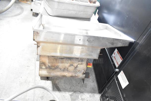 Stainless Steel Unit with aged patina, visible wear, and rust on exterior. Rectangular shape, labels warn of operation risks.