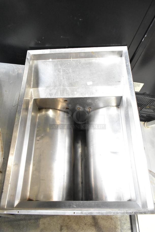 Stainless steel unit with dual compartments, used condition, features drilled holes for mounting, no visible branding.