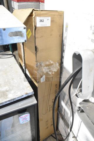 Cardboard box with "4' LED Flush Mount Puff Lights" label, shown with signs of damage but labeled as brand new, scratch and dent.