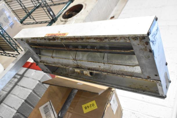 Metal countertop heat strip warmer, 115 volts, 1 phase, showing signs of wear and rust; "Caution" label visible.