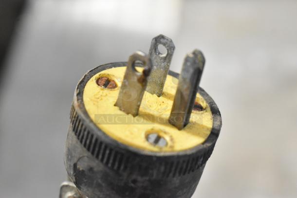 Metal Countertop Heat Strip Warmer, 115V, 1 Phase. Close-up of plug; shows three-prong connection, moderate wear.