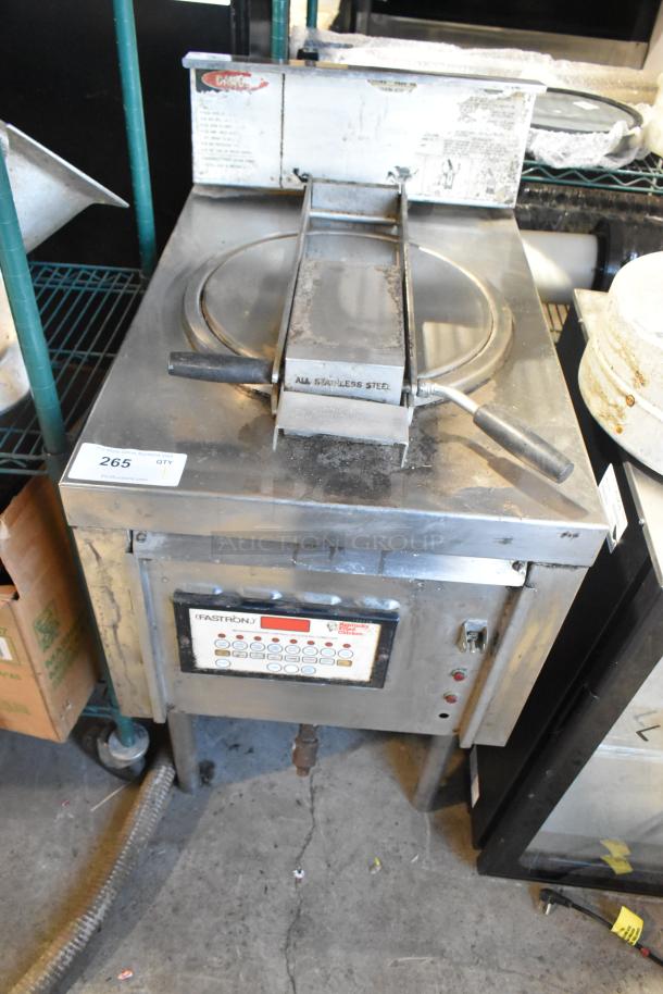 Stainless steel commercial pressure deep fat fryer, with control panel and label indicating "Fastron." Slight wear visible.