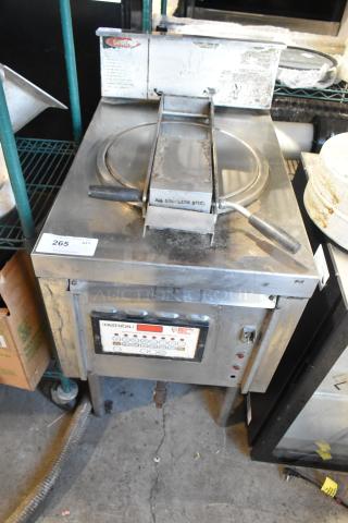 Stainless steel commercial pressure deep fat fryer, with control panel and label indicating "Fastron." Slight wear visible.