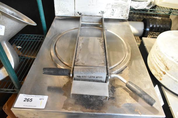 Stainless steel commercial pressure deep fat fryer, featuring sturdy handles and latch mechanism, visible surface wear.