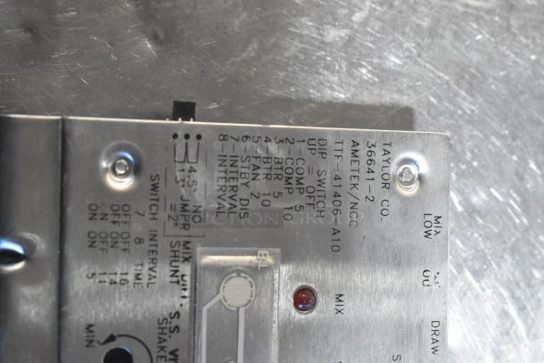 Metal component from Taylor Co. with labeled switches, model 36641-2, used for ice cream machine parts, in good condition.
