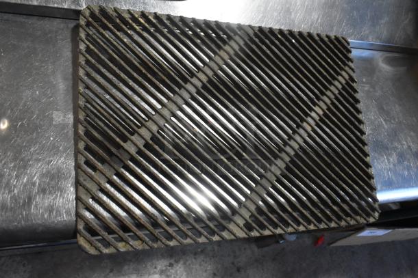 Metal grate in used condition, featuring a grid pattern. Auction for eight identical units, increasing bid value.