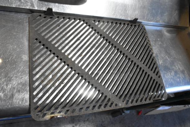 Metal grate with slotted design, slight surface wear, rectangular shape, and mounting tabs, part of set of 8 metal grates.