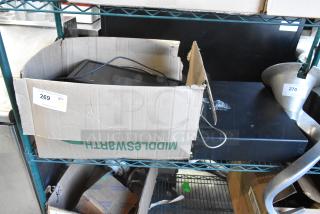 Cardboard box containing metal cash drawer and cables, labeled "269 QTY NY." ViewSonic monitor and keyboard included.