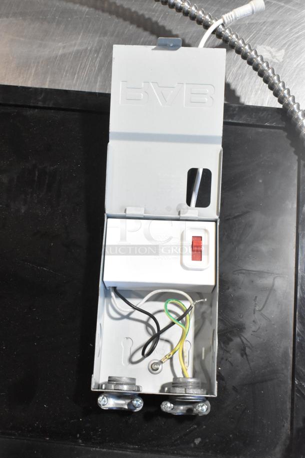 Open metal electrical box with wiring, labeled with color temperature options, black and steel components visible.