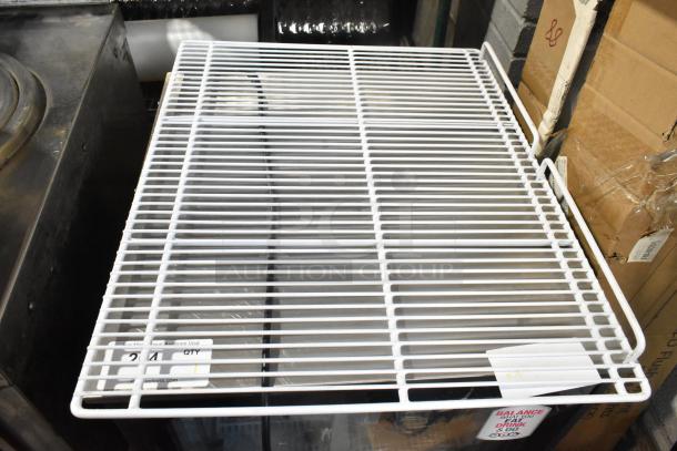 Lot of 6 white poly-coated metal racks, durable and in good condition, suitable for shelving or storage needs.