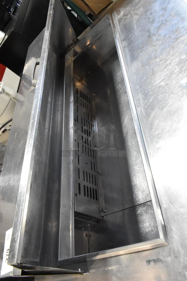 Turbo Air TST-48SD stainless steel sandwich prep table, interior view, on commercial casters in good condition.